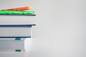 Stack of colorful books and pens