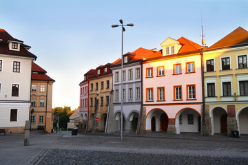 Fototapeta premium Small Square (Male namesti) in Hradec Kralove city, Czech Republic, bohemian region with its typical historical archway buildings. Dusk in the city.