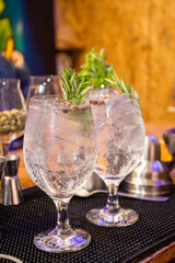 preparing alcoholic drink shots in glass glasses with lime