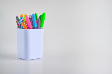 Pens in a white container cup