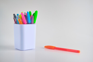 Pens in a white container cup