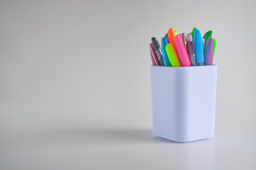 Pens in a white container cup