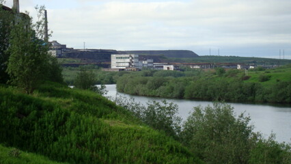 landscape on the river and bridge with a view of the coal mine North of Russia