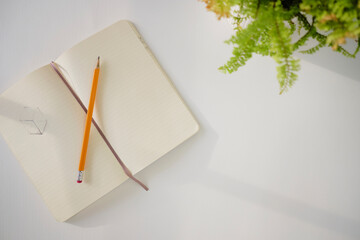 Top view of notebook on a white desk