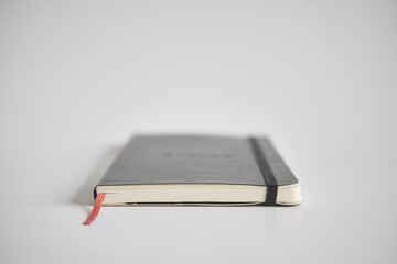 Closed notebook on a white desk