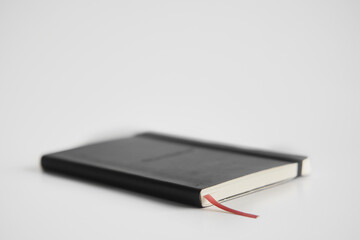 Closed notebook on a white desk