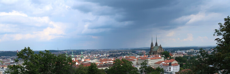 Fototapeta na wymiar Aerial view of Brno city with dark cumulus clouds above. The rain and storm is comming. Petrov, Cathedral of St. Peter and Paul. South Moravia, Czech Republic.