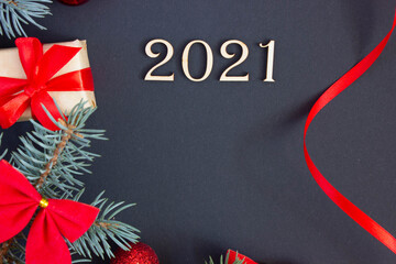 Fototapeta na wymiar new year decorations with inscription 2021 from wooden numbers on dark background