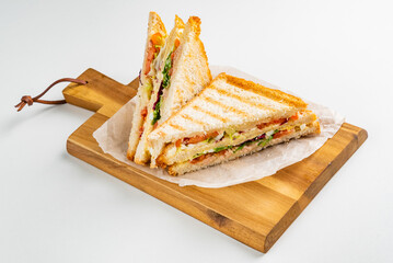 Sandwich with ham, cheese, tomatoes, lettuce, and toasted bread.