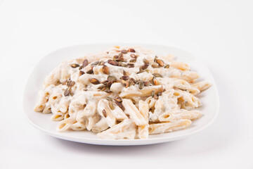 Pasta with blue cheese and cream sauce, sprinkled with roasted pumpkin seeds