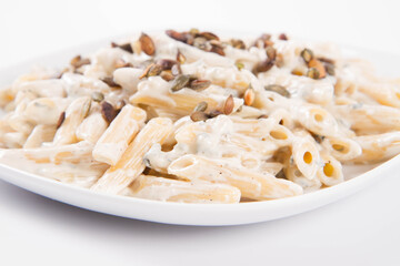 Pasta with blue cheese and cream sauce, sprinkled with roasted pumpkin seeds