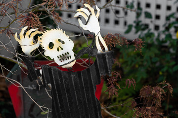 metal Halloween decoration in a garden of a skeletal ghoul wrapped in chains