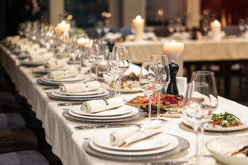Nicely served New Year's table in the restaurant. Christmas night in a cafe or at home. Stock photo for design