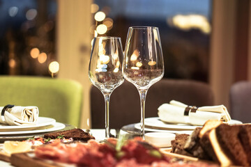Nicely served New Year's table in the restaurant. Christmas night in a cafe or at home. Stock photo for design