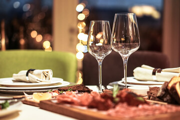 Nicely served New Year's table in the restaurant. Christmas night in a cafe or at home. Stock photo for design