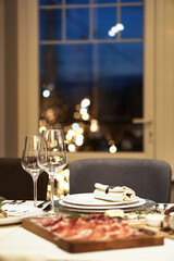 Nicely served New Year's table in the restaurant. Christmas night in a cafe or at home. Stock photo for design
