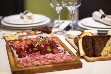 Nicely served New Year's table in the restaurant. Christmas night in a cafe or at home. Stock photo for design