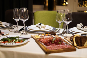 Nicely served New Year's table in the restaurant. Christmas night in a cafe or at home. Stock photo for design
