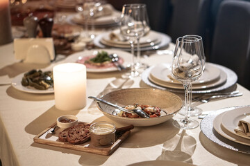 Nicely served New Year's table in the restaurant. Christmas night in a cafe or at home. Stock photo for design