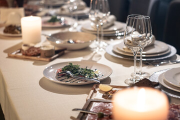 Nicely served New Year's table in the restaurant. Christmas night in a cafe or at home. Stock photo for design