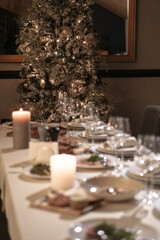 Nicely served New Year's table in the restaurant. Christmas night in a cafe or at home. Stock photo for design