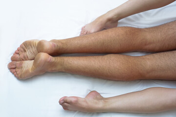 Fototapeta premium Love between a man and a woman with naked bodies. having sex in a white bed. Intimate background theme