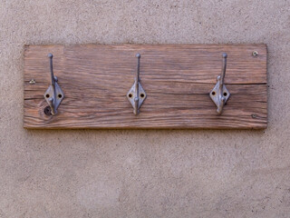 hanger bracket on the background of the concrete wall. Abandoned old hanger or hooks attached to a...