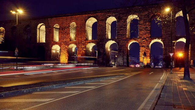 Time lapse clip near Valens Aqueduct (Bozdogan Su Kemeri) in evening with traffic of cars, Istanbul, Turkey. It was a water-providing system of the Eastern Roman capital Constantinpole