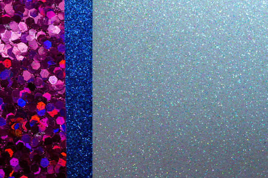 Full frame sparkling light silver blue glitter texture background with rosy red and blue glitter border. With bokeh and copy space.