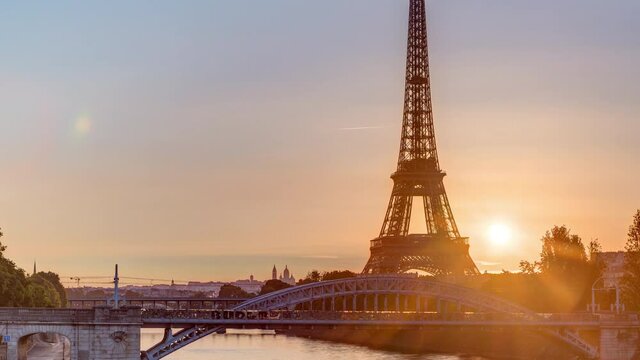 Eiffel Tower sunrise timelapse with boats on Seine river and in Paris, France. View from Grenelle bridge.