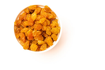 Yellow raisins in a white plate on a white background
