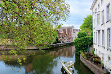 Fototapeta na wymiar Streets of Brugge. Canals of Brugge Belgium. Canal reflecting the streets of the city. Beautiful city of bruges in Belgium.