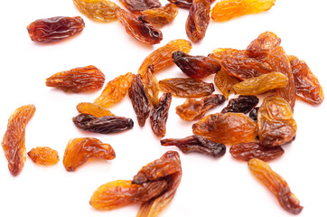 Handful of brown and yellow raisins on white background