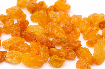 Handful of appetizing yellow raisins on a white background