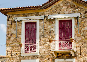 Windows on a house in the Greek village of Evia 