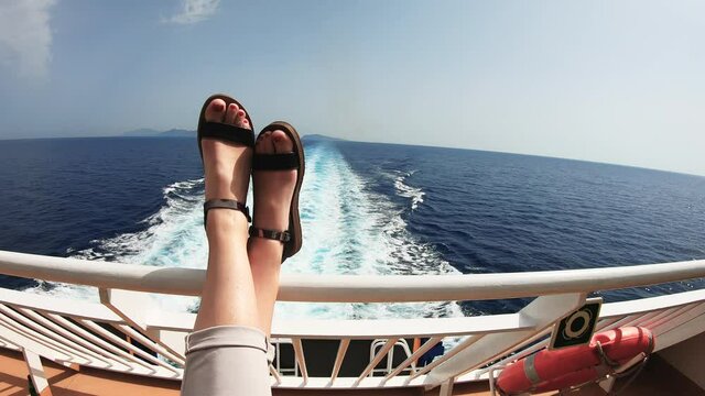 Legs of a woman on a yacht in the sea, cruiser boat trip