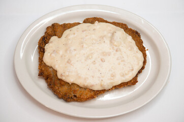 Chicken fried steak, also known as country-fried steak, is an American breaded cutlet dish consisting of a piece of beefsteak coated with seasoned flour and pan-fried.