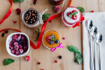 beautifully decorated panna cotta on the table with scattered fruits and decorations