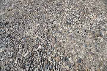 Destroyed road in poor condition requiring repair. Holes in the asphalt are filled with water and puddles. Stock photo background