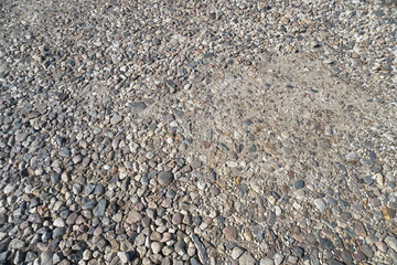 Destroyed road in poor condition requiring repair. Holes in the asphalt are filled with water and puddles. Stock photo background