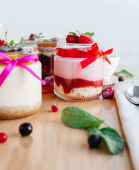 beautifully decorated panna cotta on the table with scattered fruits and decorations