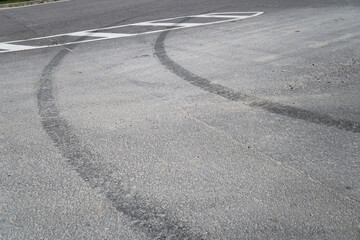 Tire marks on the asphalt. Good brakes and correct distance from the vehicle. Car safety theme