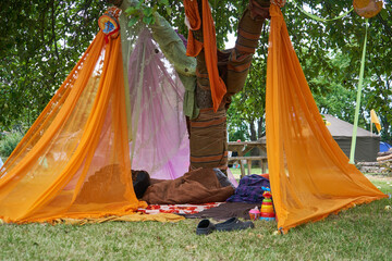 Tree decorated with various colorful fabric pieces in the festival
