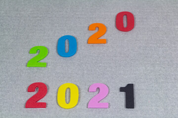 2021 and 2020 in multicolored number on gray background