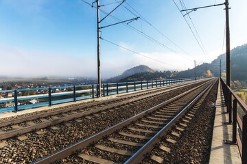  Railway tracks. Rail transport. Train transport. Autumn foggy morning. Rural landscape with railway tracks in the Czech Republic.