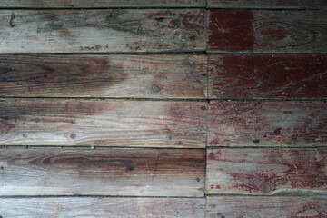 Old board in erased paint. Wooden wall of an old building. Background for design.
