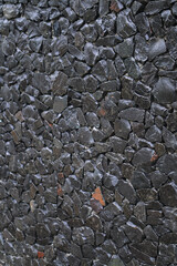 Rubble wall for protection from thieves. a stone on which water flows. Texture for the background.