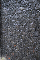 Rubble wall for protection from thieves. a stone on which water flows. Texture for the background.
