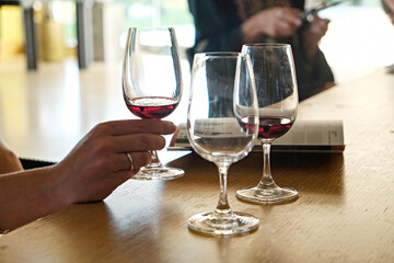 Wine glasses display at winery. Close up, copy space, background.