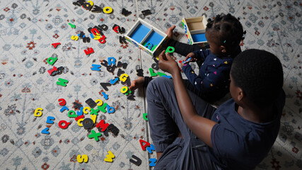 children playing with wooden alphabet